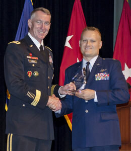 Air Force Major James Day receives the Col. Thomas Felts Leadership Award from Lt. Gen. Gary H. Cheek, the guest speaker for the SAMS Class of 2016 graduation ceremony conducted on May 26 at Fort Leavenworth.  The Felts award is considered the top award for SAMS graduates.