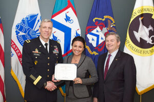 CGSC Deputy Commandant Brig. Gen. Scott L. Efflandt, left, and CGSC Foundation Chair Michael Hockley, right, present an NSRT certificate of completion to Michelle Kay, vice president and general manager of Enterprise Holdings.