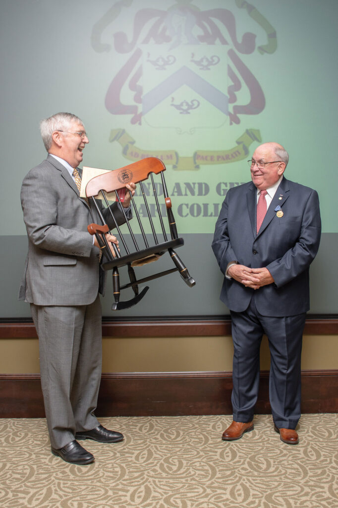 Foundation President/CEO Doug Tystad presents a child-sized College Chair to Dr. Jim Willbanks, drawing laughter from everyone in attendance during Willbanks' retirement ceremony April 24. 