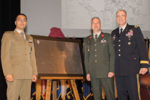 Majors Stefano Catania, Italy (left), and Rene Berendsen, Netherlands, present the International Military Student Class of 2018 gift to Brig. Gen. Scott Efflandt during the International Military Student Badge Ceremony June 14. The gift is a map showing the names and countries of the 119 international students graduating from Command and General Staff Officers Course 2018. 