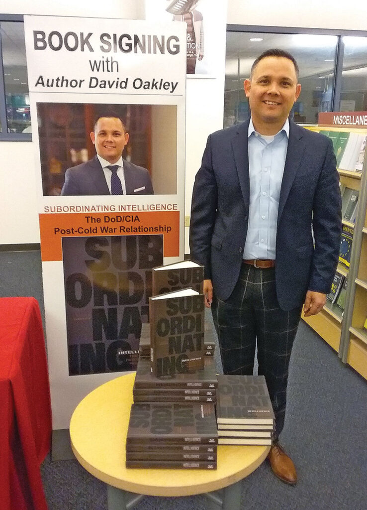 Lt. Col. David Oakley, an assistant professor at the National Defense University and author of "Subordinating Intelligence: The CIA/DoD Post-Cold War Relationship," takes time for a photo in the AAFES Bookstore in the Lewis and Clark Center on April 17.