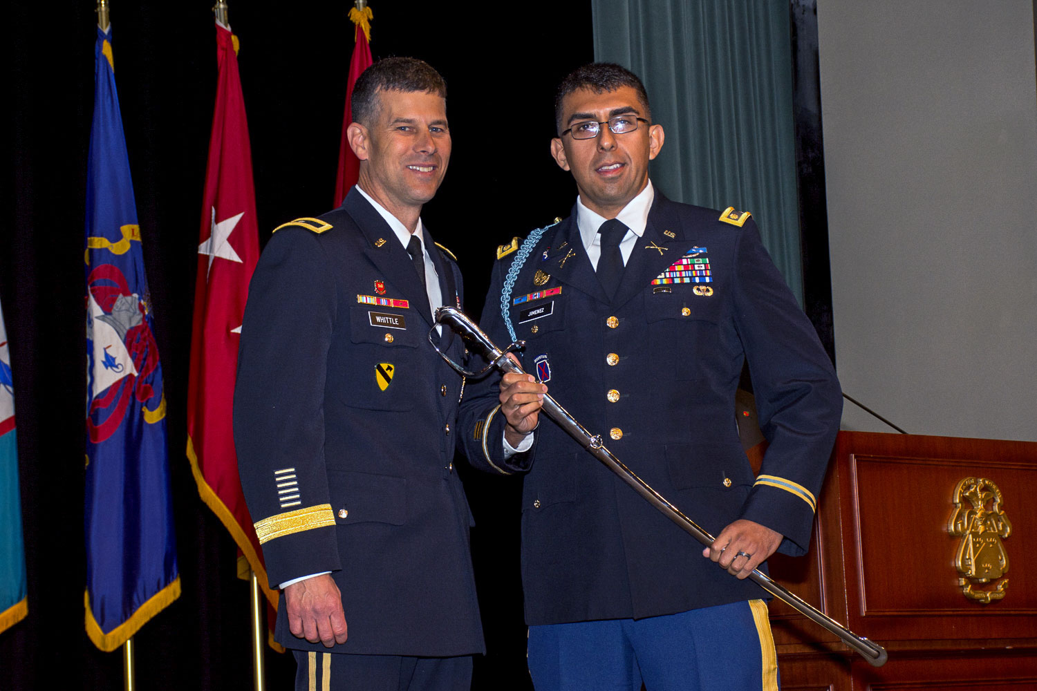 Photo of Major Moises Jimenez receiving the Colonel Thom Felts Leadership Award, an Army saber, from graduation guest speaker Brig. Gen. Robert F. Whittle, Jr., commandant of the U.S. Army Engineer School at Fort Leonard Wood, during the SAMS graduation ceremony May 23, 2019.