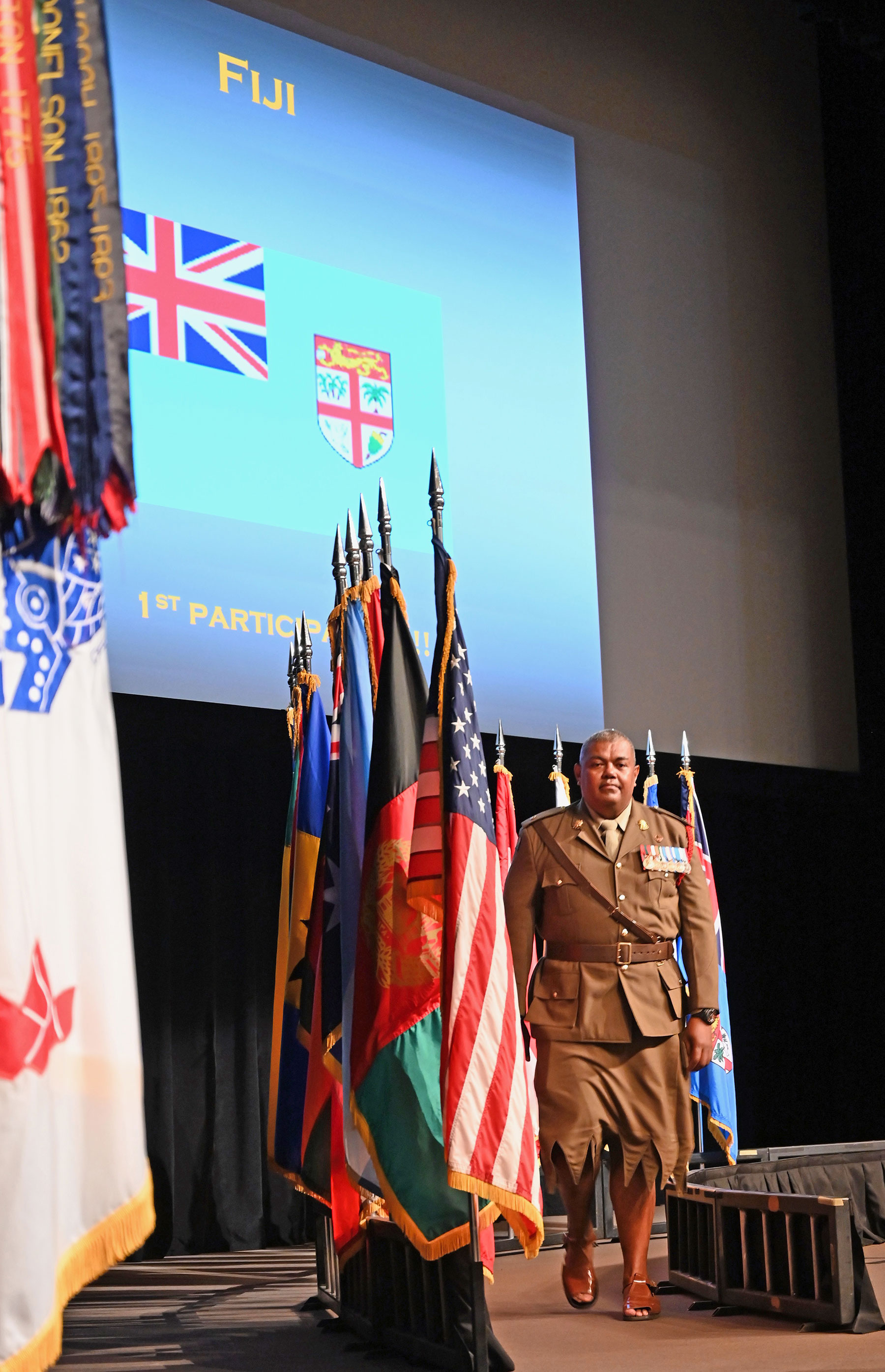 The first-ever international military student from Fiji marches off stage after posting his nation's colors during the CGSC Class of 2020 Flag Ceremony on Aug. 5, 2019.