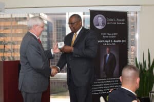 Powell Lecture AUG w CGSC Foundation President/CEO Doug Tystad presents Gen. Lloyd J. Austin III, U.S. Army, Ret., with a Colin L. Powell Lecture Series silver commemorative coin for his support of the program.