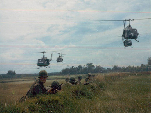 US Army taking cover in field