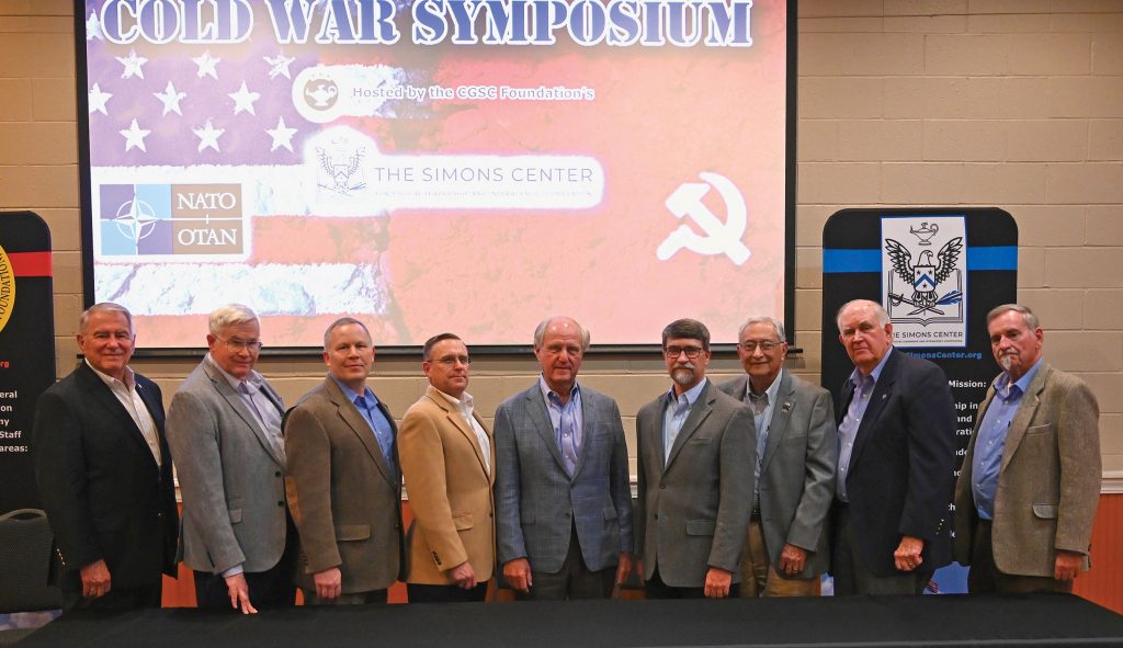 Simons Center Director Bob Ulin, left, with the panel of experts he assembled for the Cold War Symposium. From left, Ulin; Col. (Ret.) Jon House, Ph.D., Professor Emeritus, CGSC Department of Military History; Robert Davis, Ph.D., Director, Goodpaster Scholars, School of Advanced Military Studies; Sean Kalic, Ph.D., Professor, CGSC Department of Military History; John Ferguson, owner of Ferguson Hotel Development, the symposium’s sponsor; Mark Wilcox, Ph.D., Associate Professor, CGSC Department of Joint, Interagency, and Multinational Operations; Gilbert Bernabe, Ph.D., former inspector for the On-Site Inspection Agency; William Eckhardt, JD, Emeritus Teaching Professor of Law, Director, Urban Affairs Outreach, University of Missouri-Kansas City; and Lester Grau, Senior Research Analyst, Foreign Military Studies Office. Not pictured in the group are Tim Riley, Director and Chief Curator, America’s National Churchill Museum, Fulton, Mo.; and Maj. Gen. (Ret.) Gordon “Skip” Davis, a former CGSC deputy commandant and NATO Deputy Assistant Secretary General for Defense Investment.