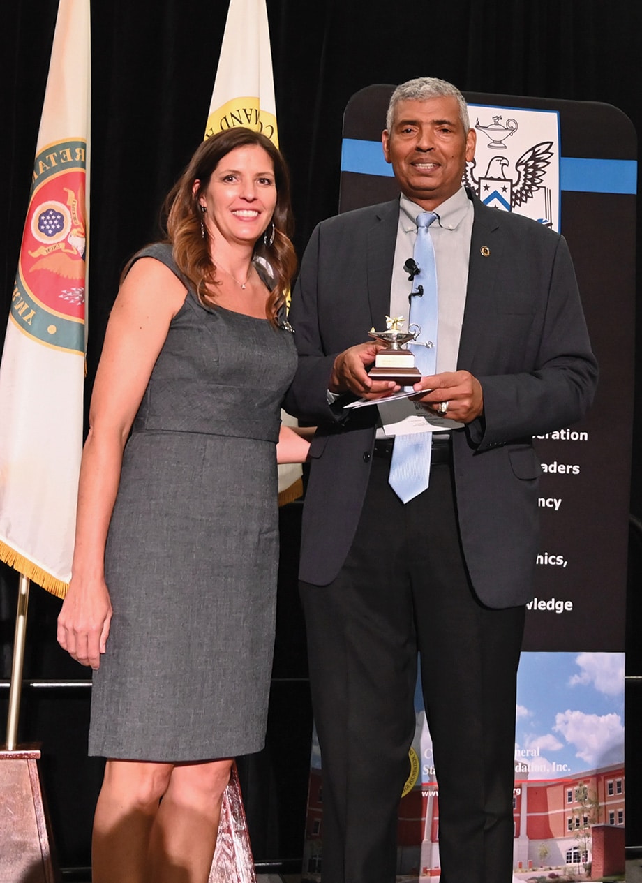 DSS Powell Lecture Dinner w CGSC Foundation President/CEO Lora Morgan presents Gen. (Ret.) Vincent Brooks with a Fort Leavenworth Lamp statuette in appreciation for his time with the Foundation and its guests at the Foundation's Distinguished Speaker Series dinner event in downtown Kansas City Aug. 28, 2024.